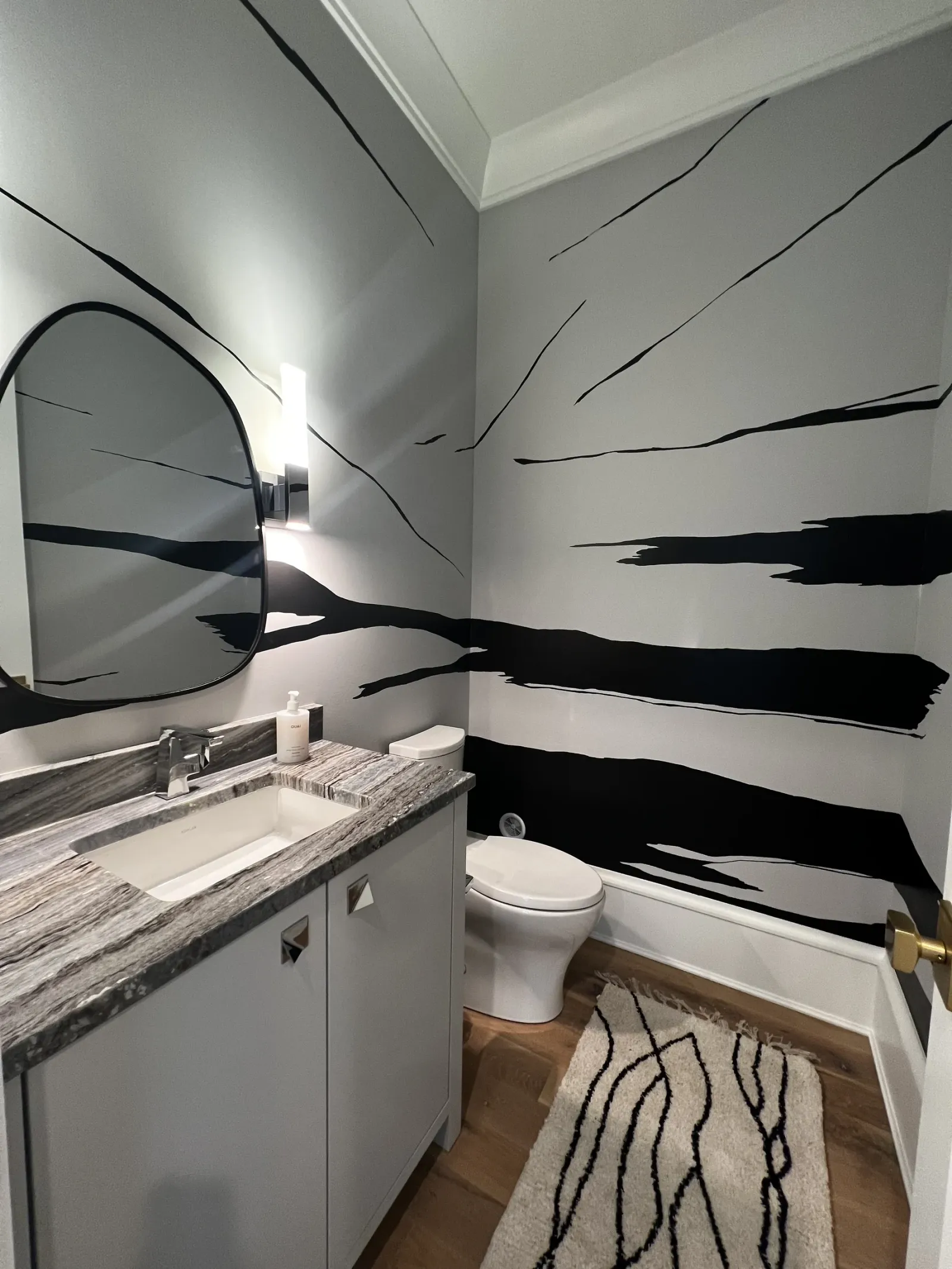 White bathroom walls with sweeping black brushstrokes